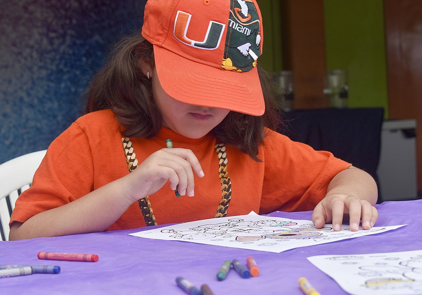 Olivia Ponce, 7, colors before the mermaid show.