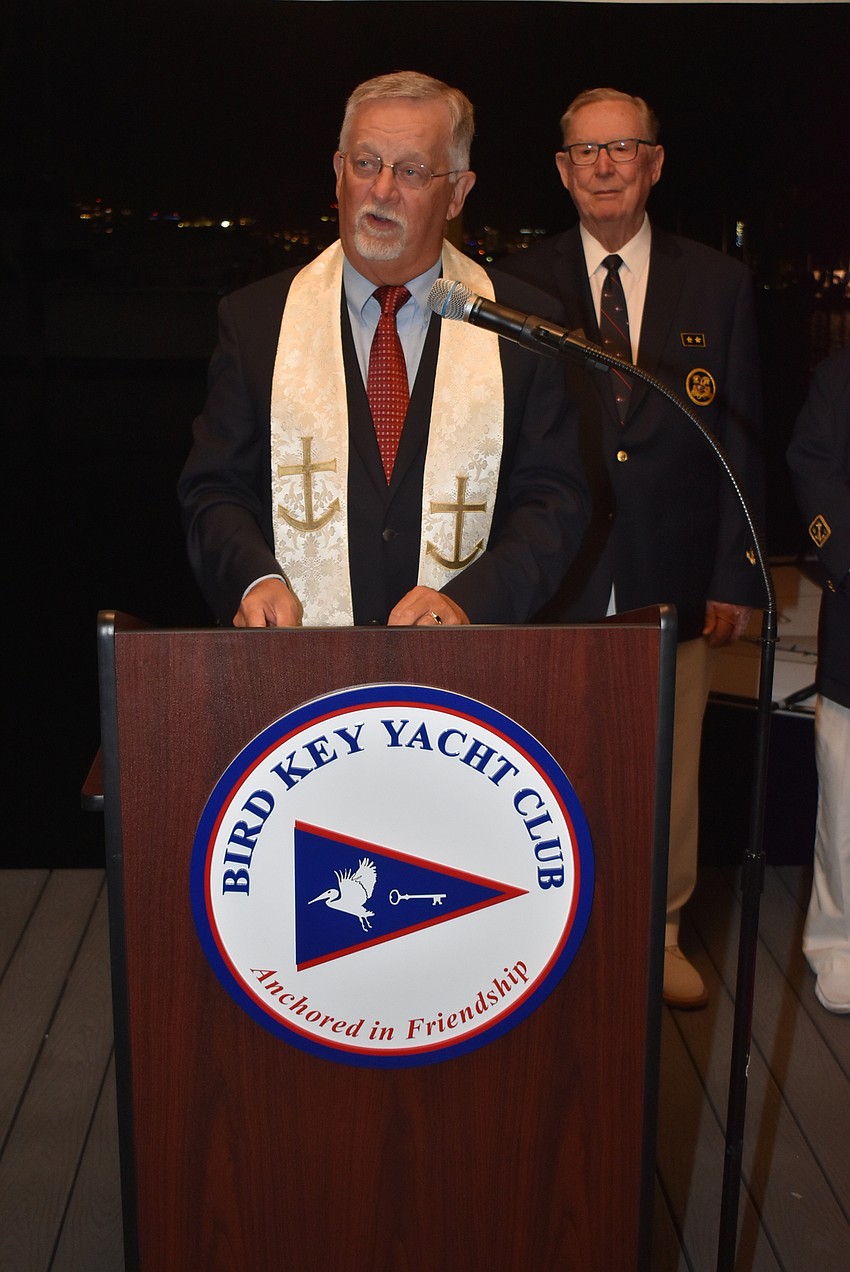 The Rev. Craig Collemer blesses the fleet with Vice Commodore Jim Chadwick in the background.