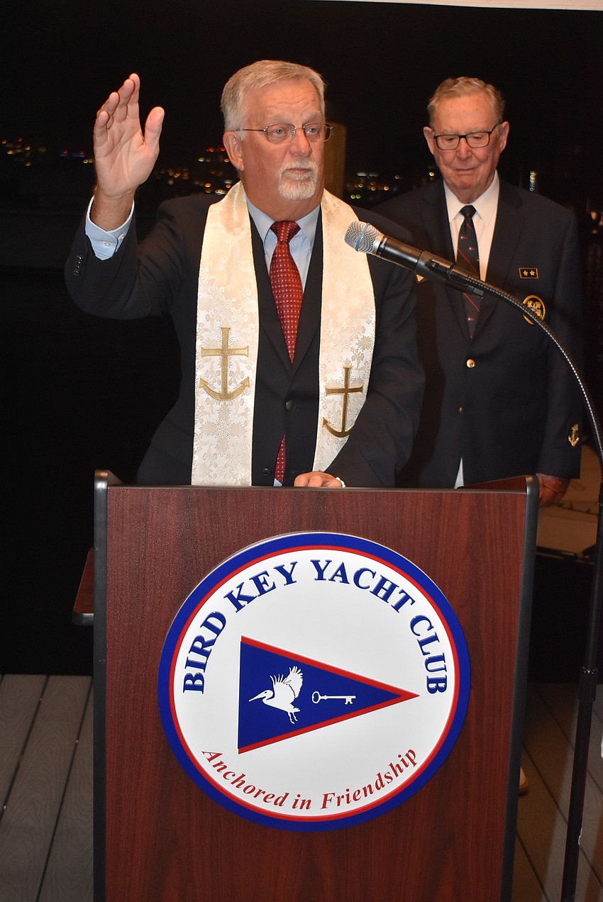 The Rev. Craig Collemer blesses the fleet with Vice Commodore Jim Chadwick in the background.