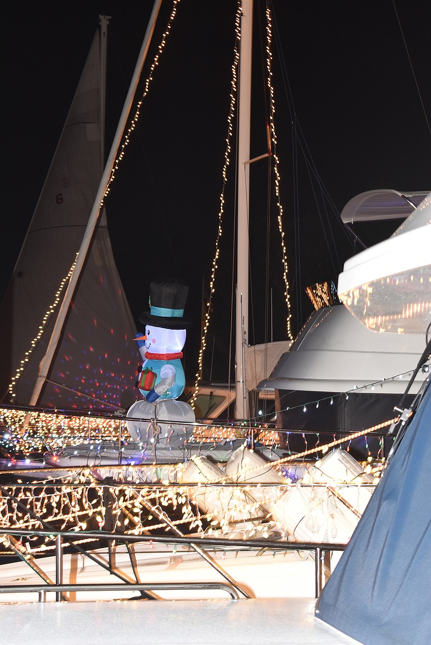 A snowman waves from one boat.