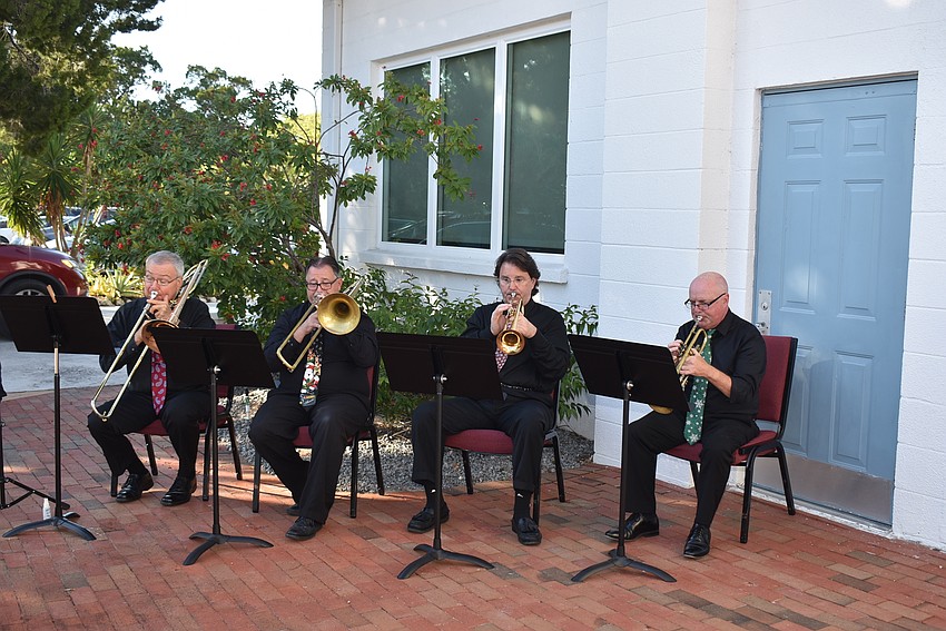 Trombonists Greg Nielsen and George Mancini warm up with trumpeters Alan Evans and Rick Louis.