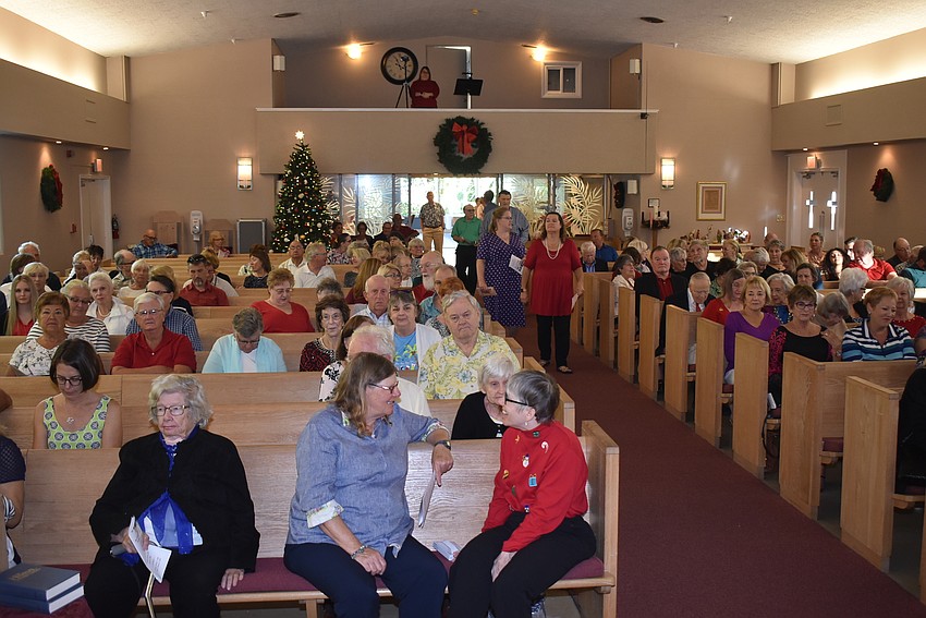 Audience members trickle into the church for the concert.