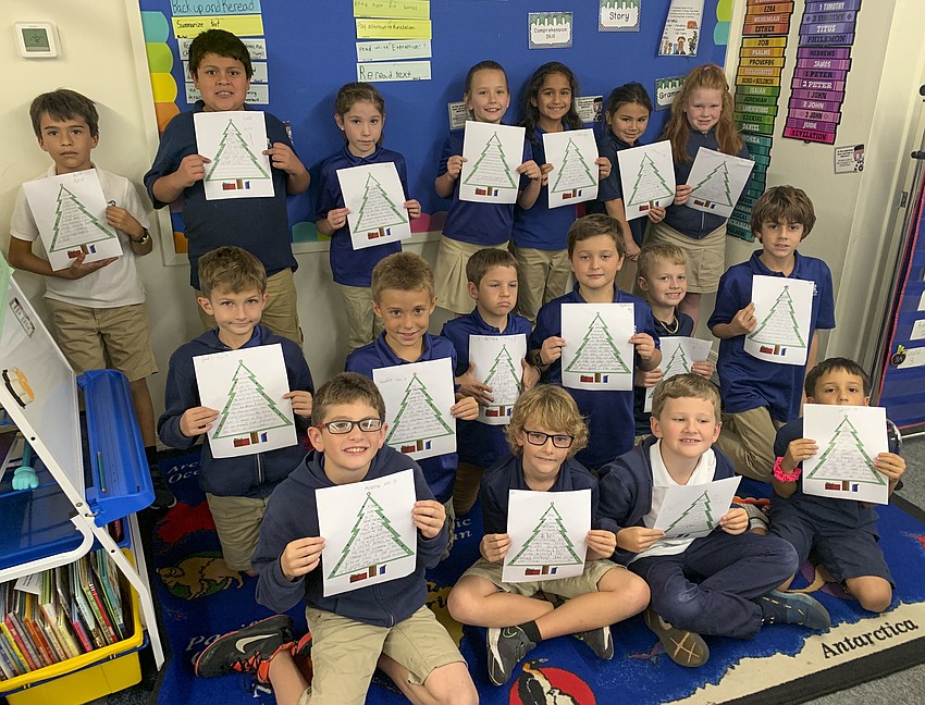 Randi Tedder's third grade class hold up their 