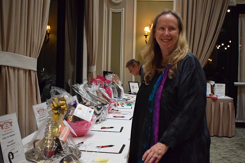 Nan Sheldon-Martin, a member of the Lakewood Ranch Women's Club, looks over the 41 baskets she created for the silent auction. It took Sheldon-Martin about a month to complete the baskets. All proceeds go to charity.