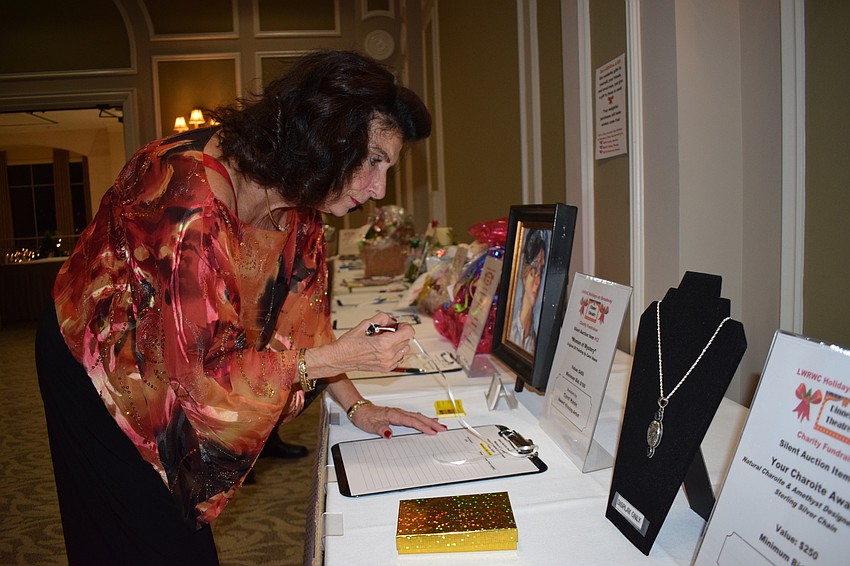 Sharon Wright, the 2020 entertainment chair for the Lakewood Ranch Women's Club, browses the baskets in the silent auction. 