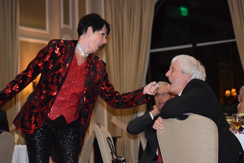 Kay Siebold with the Players Centre for Performing Arts holds her hand out like a microphone to Lakewood Ranch's Tom Wilson during a sing along of 