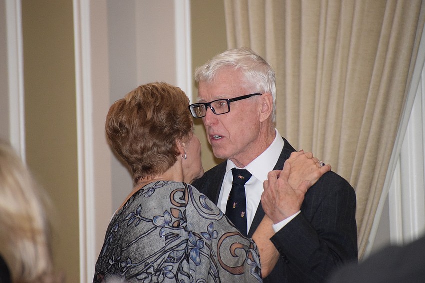 Paul and Mary Lee Danahy dance while about 130 people sing 