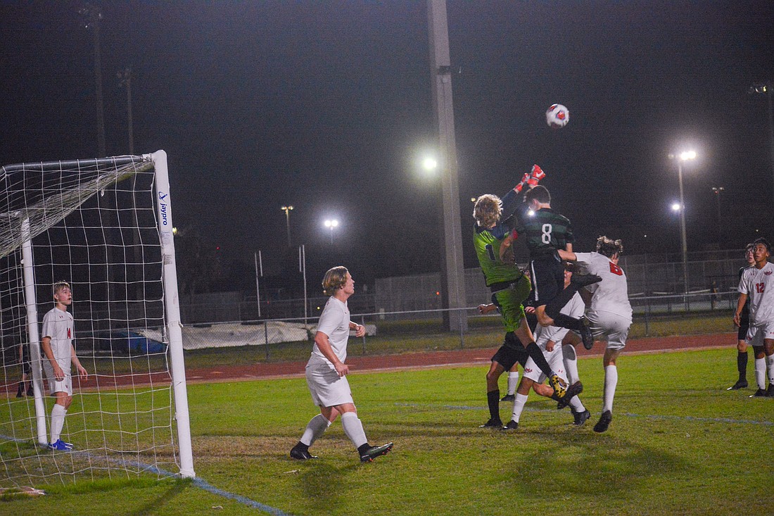 Lakewood Ranch senior forward Jacob Jordan (8) goes for a header against Manatee High. He had two goals in the game.
