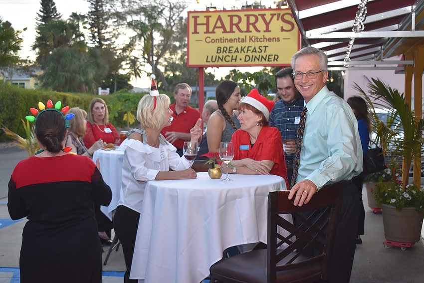 Michael Vejins smiles while chatting with friends.