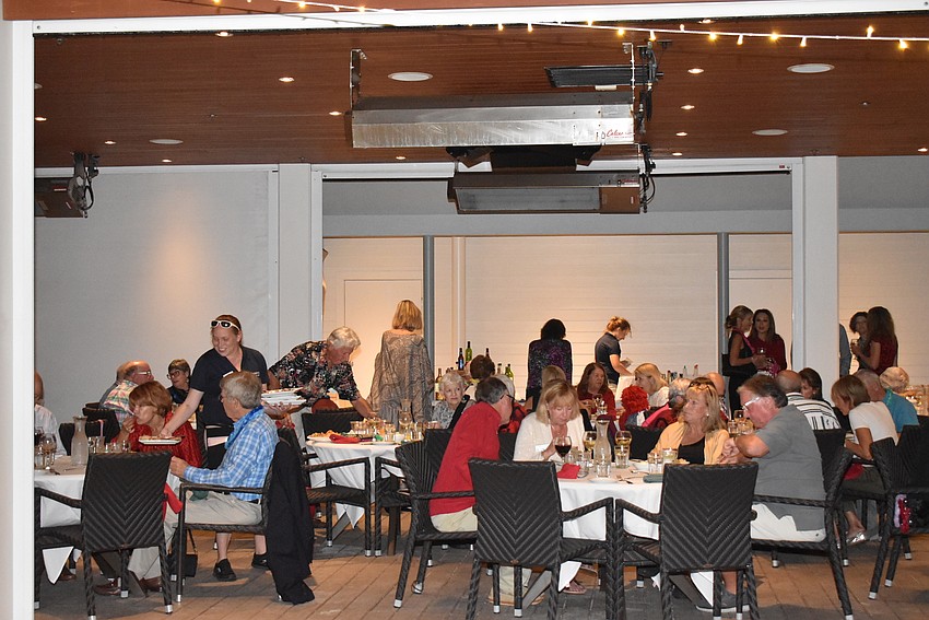 Members dined together under twinkling lights.