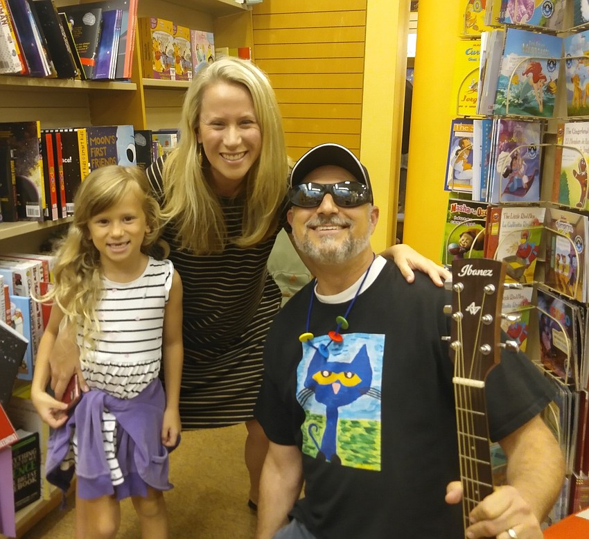 Temple Emanu-El Associate Rabbi Michael Shefrin greeted Lauren and Raina after his musical storytelling performance .