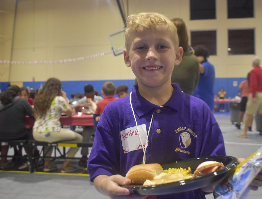 Hunter Svetik, 6, poses with his holiday dinner.