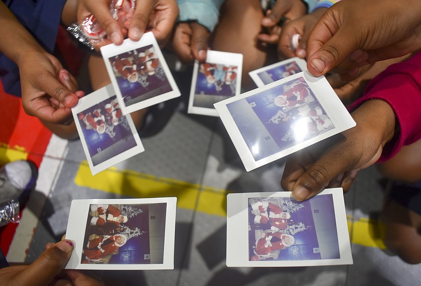 Each child was able to take a polaroid photo with Santa and Mrs. Claus.