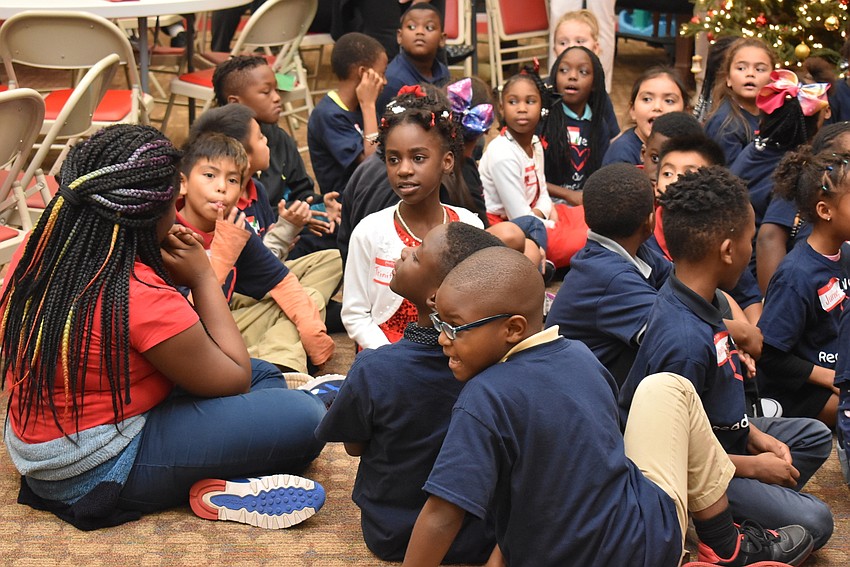 Kids turn their heads as they wait for Santa.