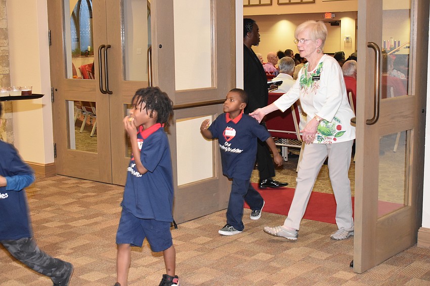 Children file out for dinner.