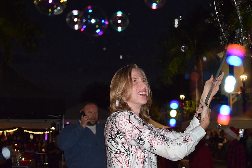 Land O' Lakes' Blaise Ryndes creates bubbles for kids to try to pop. Ryndes was on season 13 of America's Got Talent.