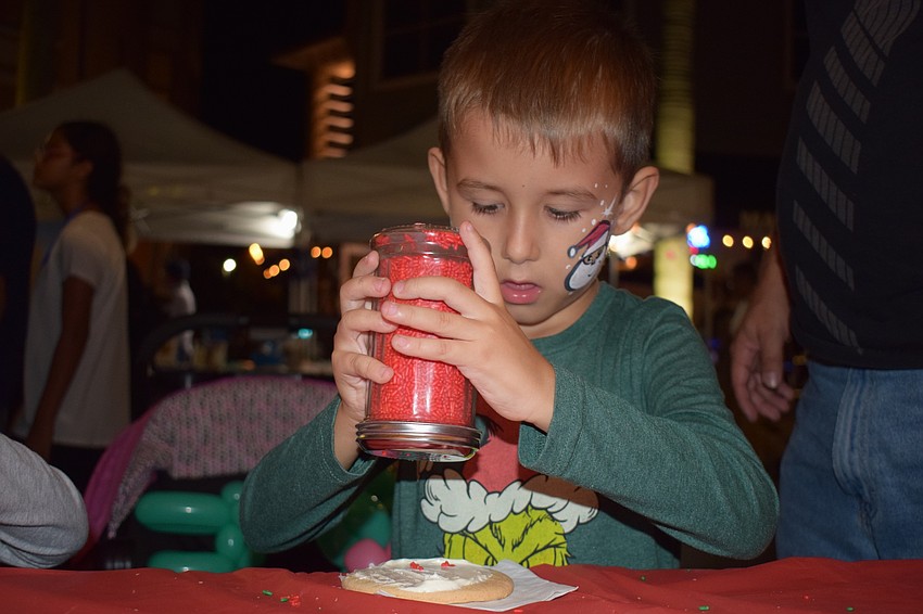 Sarasota's Daniel Hodzie, 5, showers his cookie in red sprinkles.