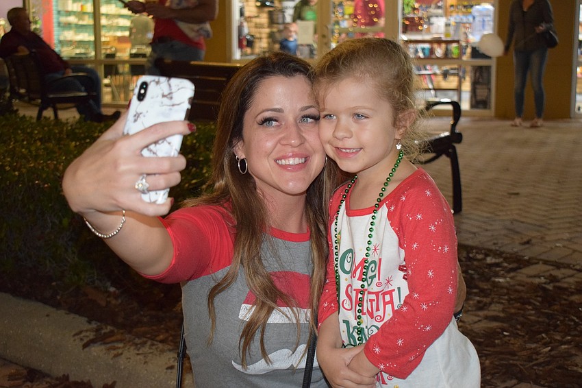 Lakewood Ranch's April Leveque and Ainsleigh Olszewski, 5, take a selfie to commemorate their time at Holidays Around the Ranch. Olszewski said her favorite part what seeing her teachers from school at the event.