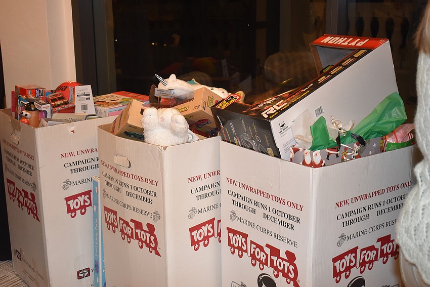 Three boxes overflowed with Toys for Tots.