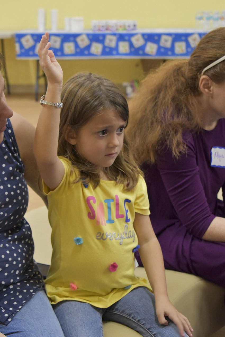Ainsley Beasley, 5, raises her hand to share what she's thankful for.