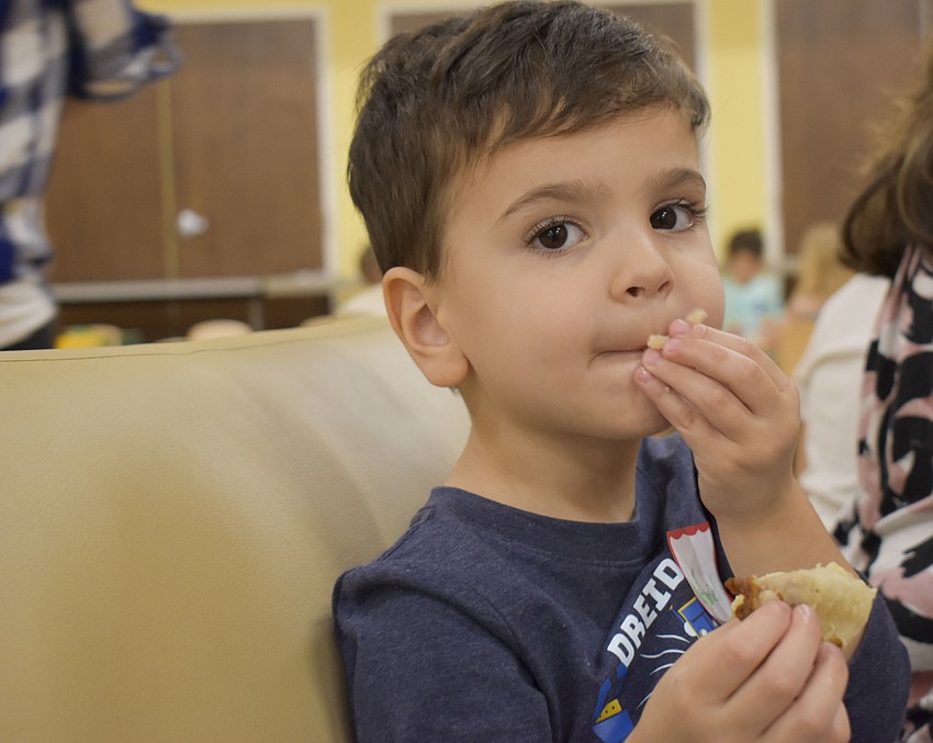 Nathaniel Marcus, 3, eats his latke.