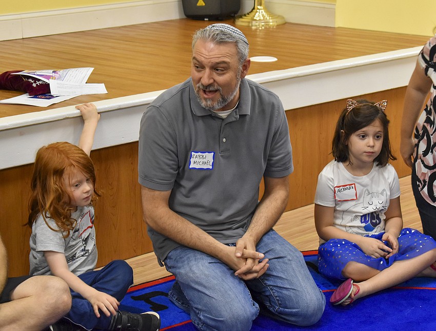 Avi Sigal, 2, Rabbi Michael Shefrin and Alexandria Marcus, 6