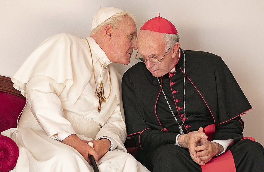 Anthony Hopkins, left, as Pope Benedict XVI, has a few quiet words for  his successor, Pope Francis (Jonathan Pryce) in The "Two Popes." (Courtesy photo)