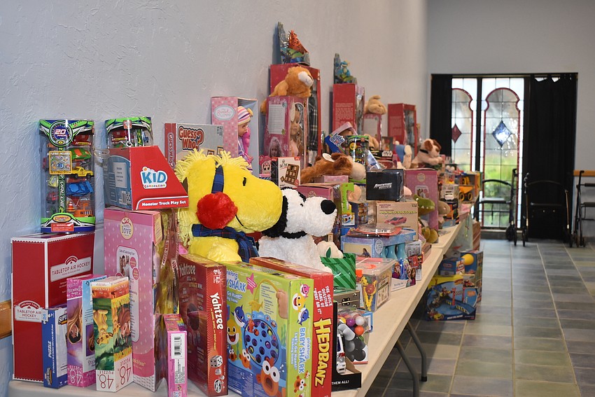 Dozens of toys were heaped on a table.