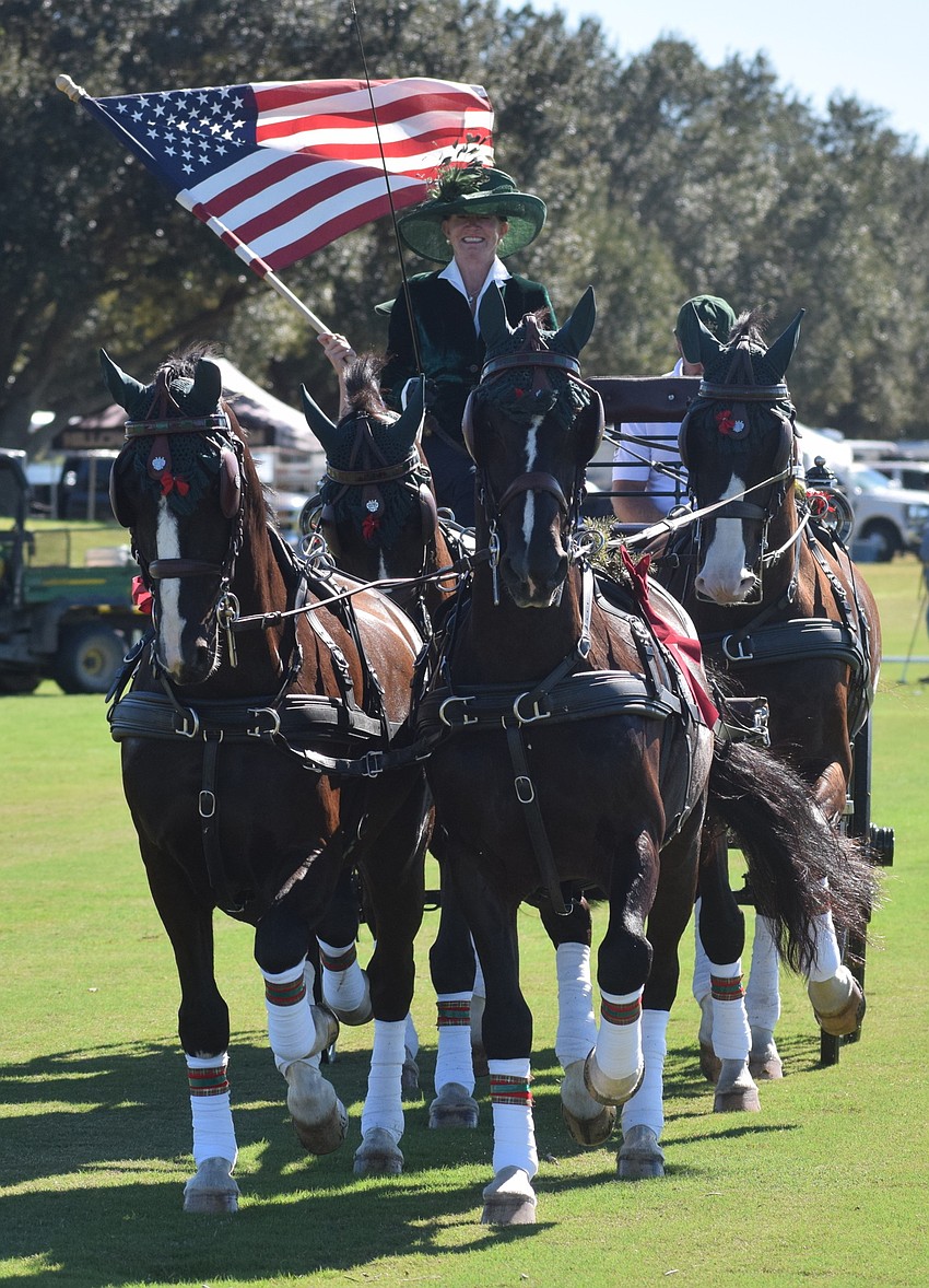 Sarasota Polo Club owner Misdee Miller leads a team of horses on opening day.