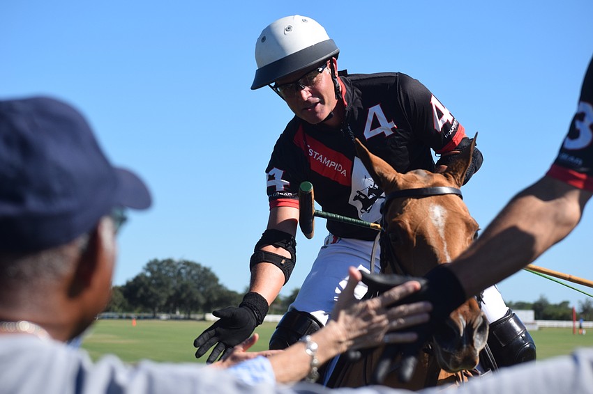 Sarasota Polo Club owner James Miller greets the fans along the sideline.