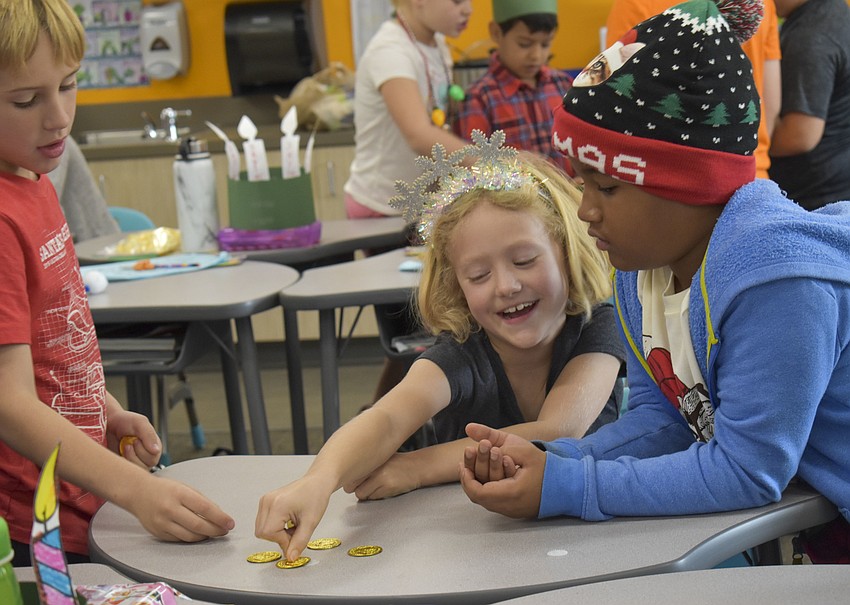 Hudson Conway, Caedance Day and Noah Saintcyr divvy out coins.