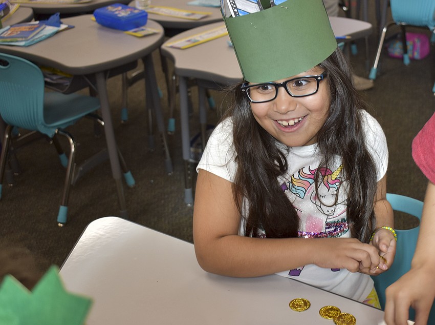 Madelyn Vega gets ready to spin her dreidel.