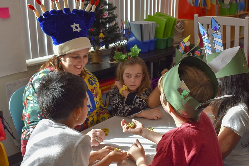 Michala Chipurnoi plays the dreidel game with a some of her students.