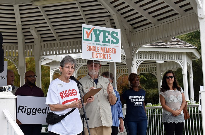 Kindra Muntz, president of Sarasota Alliance for Fair Elections, speaks to protestors.