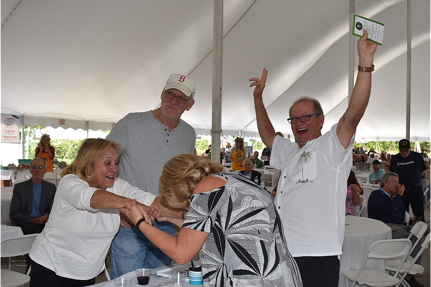 John and Karen Henry celebrate their win of the $20,000 raffle prize with Bill and Susanne Weber at the 2019 Lawn Party.