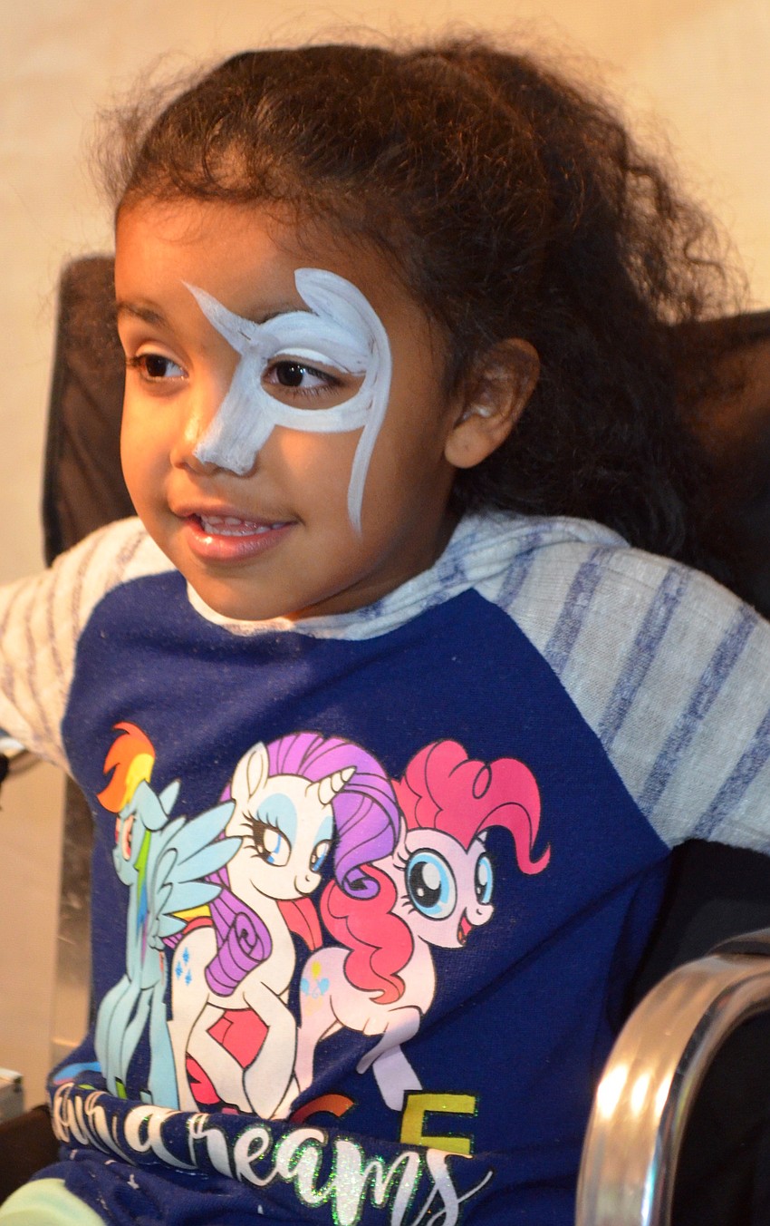 Ryleigh McDowell, 4, sat for a face-painting session with her parents nearby.