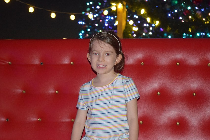 Ella MacIntyre, of Venice, sits in Santa's sleigh.