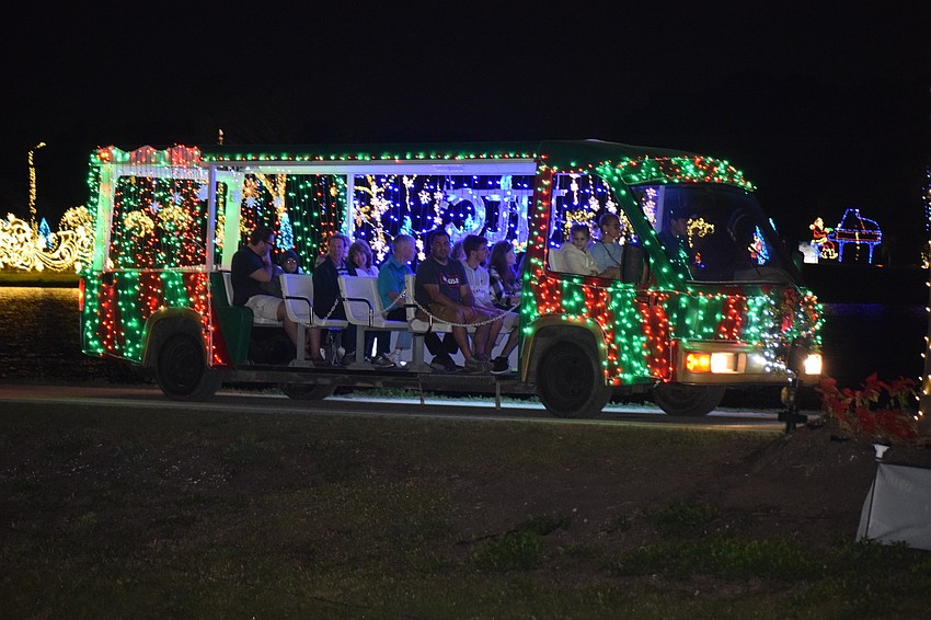 People enjoy viewing the light displays around the lake during Holidays on the Green.