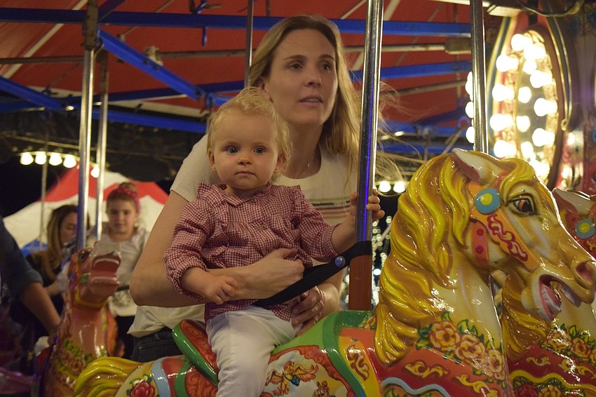 Lakewood Ranch's Nicole Stepaeak rides on the carousel with her daughter, Stella.