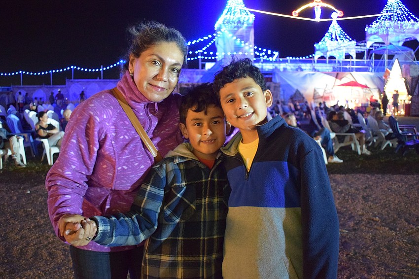 Sarasota's Maria Lopez and Santiago and Mateo Godoy dance to the music being played during the light show. The Godoys enjoyed sledding, especially after missing an opportunity to sled in New York during Thanksgiving.