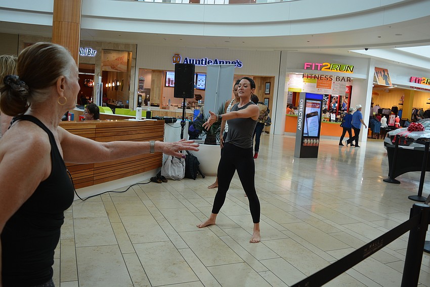 Barre 3 instructor Niki Dalsing leads a free class in front of the playground area.