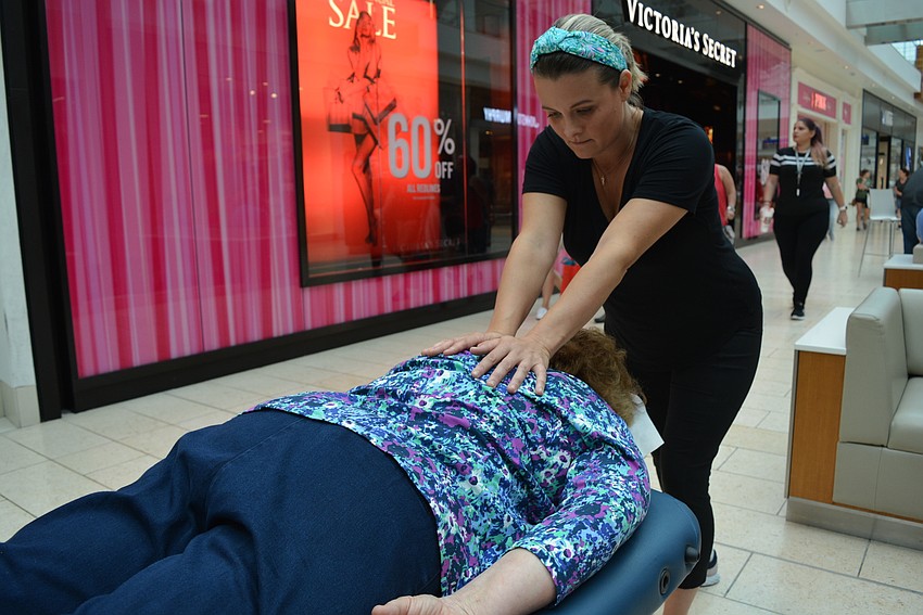 Four Pillars massage therapist Agusta Raffo works on East County resident Beverly Cattanach.
