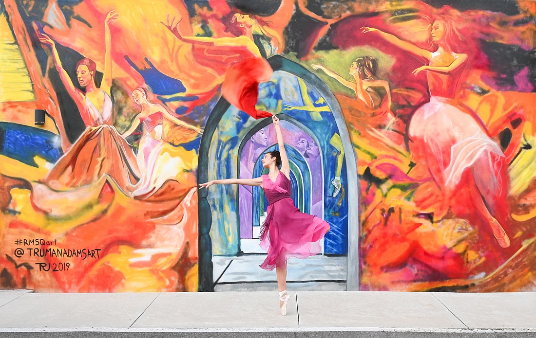 Thaleia G. Dasberg almost blends into Truman Adams&#39; ballet mural at Rosemary Square. (Photo: Andrea Hildebrand)