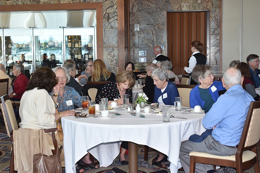 After the presentation, attendees talk amongst themselves.