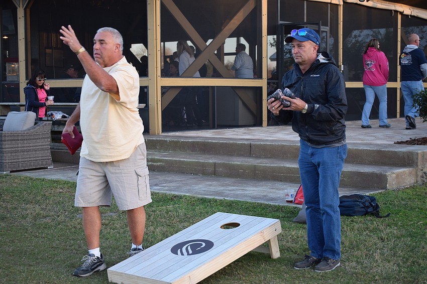 Doug Connolly, of Ellenton, and Ken Harpley, of Palmetto, play a round of cornhole. The two are part of MVP Sports and Social's cornhole league.