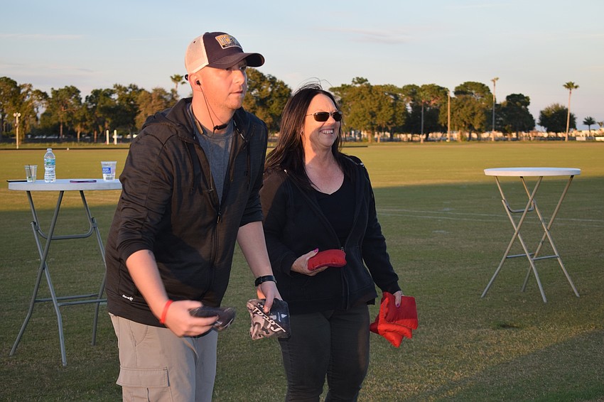 Lakewood Ranch's David Webster and Sarasota's Beth Houghtaling play cornhole. 
