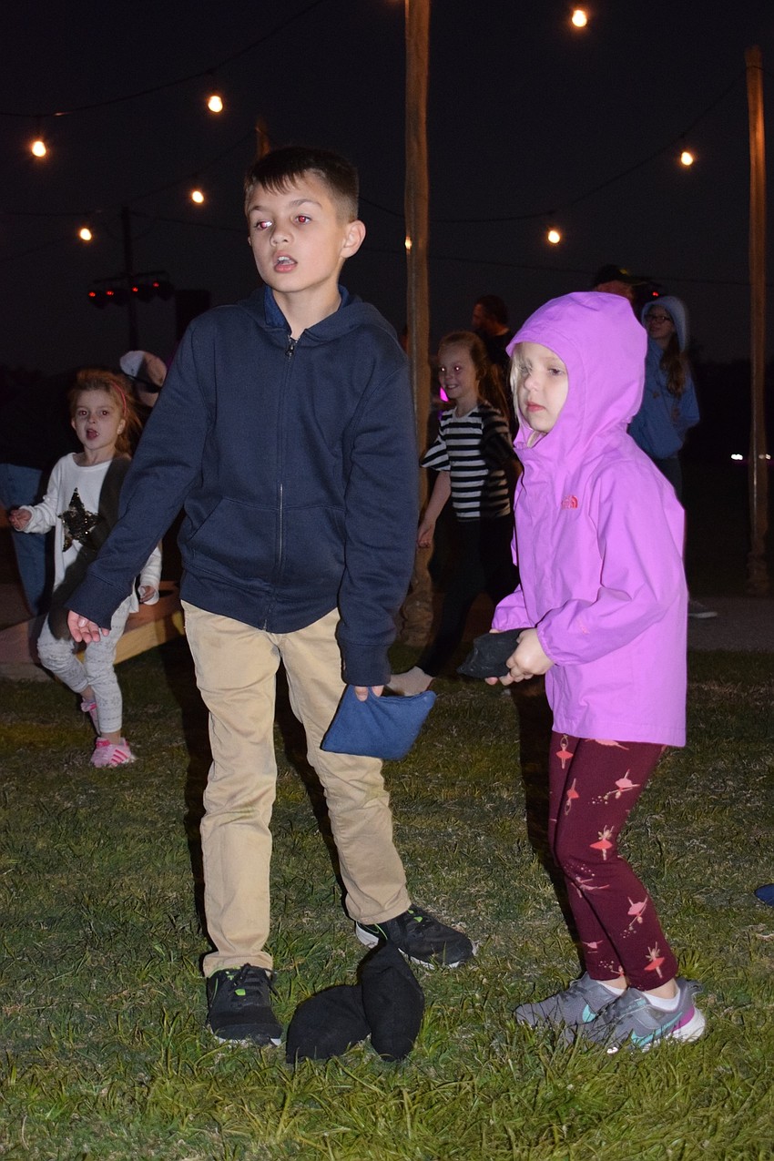 Lakewood Ranch's Liam and Veronica Holt play cornhole together. The Holt family moved to the area last summer.