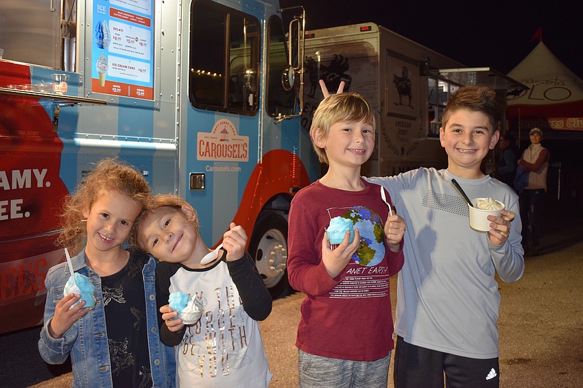 Lakewood Ranch's Madison Rivera, Lexi Truxton, Tyler Truxton and Colton Ross eat ice cream from Carousel's and American Honey Creamery food trucks.