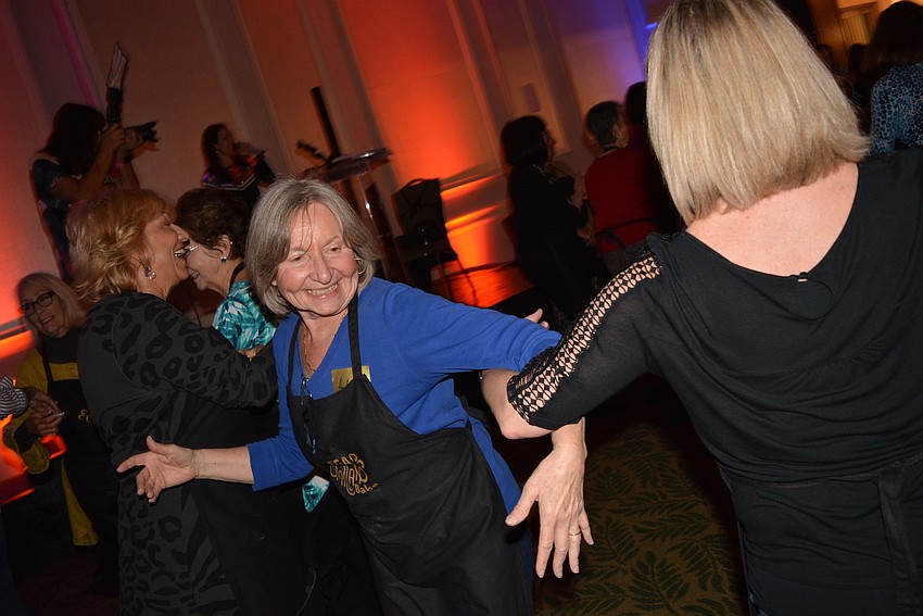 Lakewood Ranch's Lisa Cuker enjoys dancing with friends just before the women settle down to separate and braid their dough in the loaves they will take home.