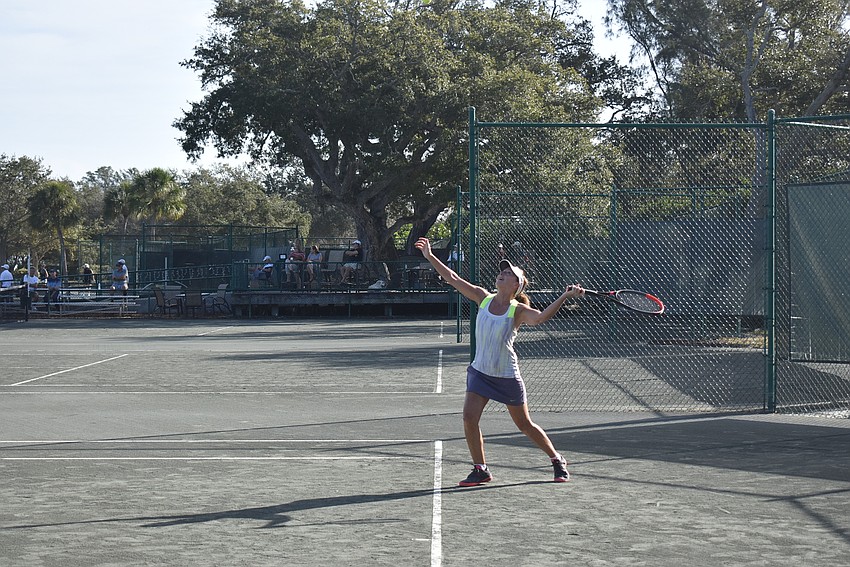 Ellen Day serves in a singles match.